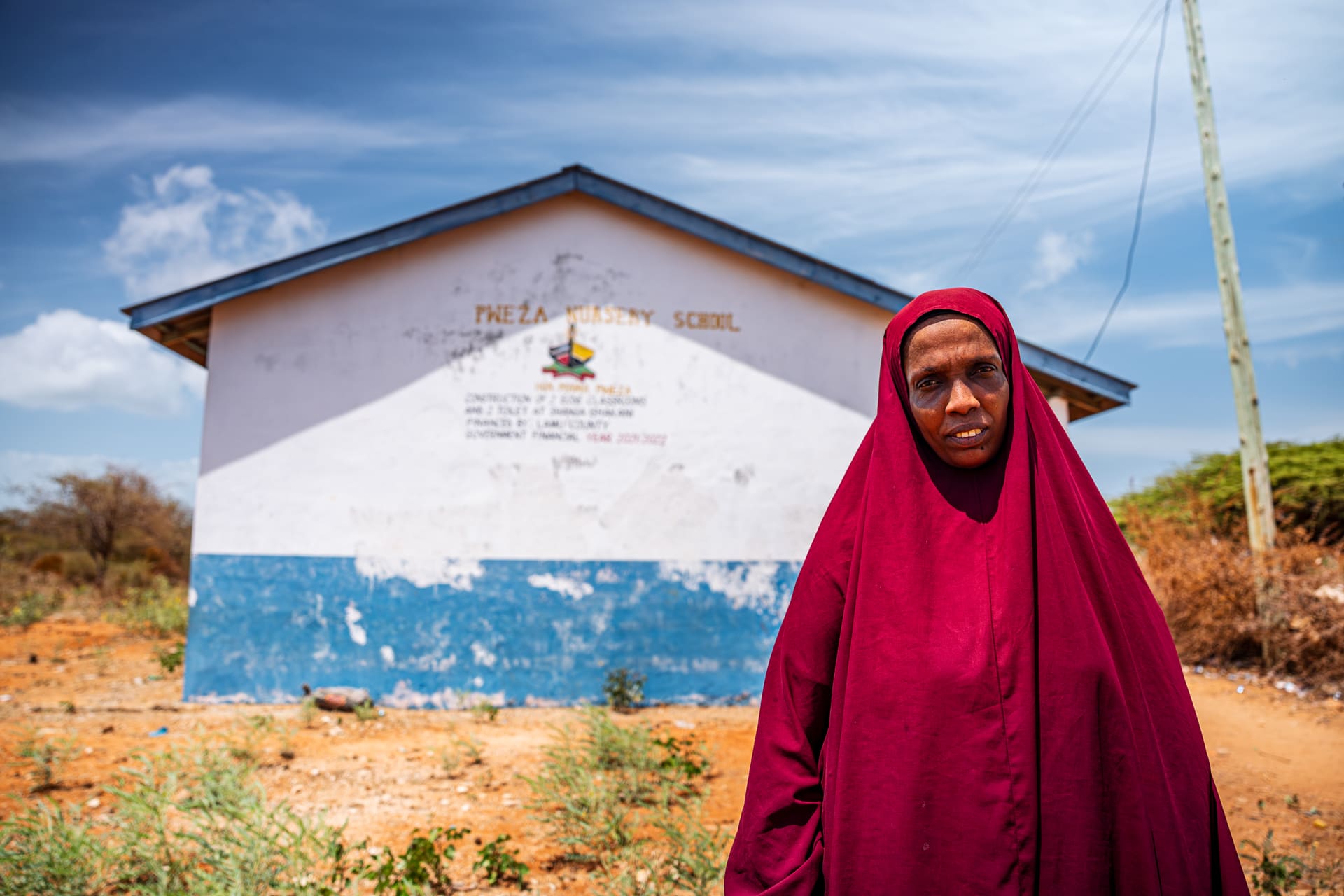 A woman in front of her local school